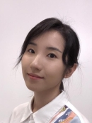 head shot of Asian woman with black hair pulled into a ponytail wearing a white shirt